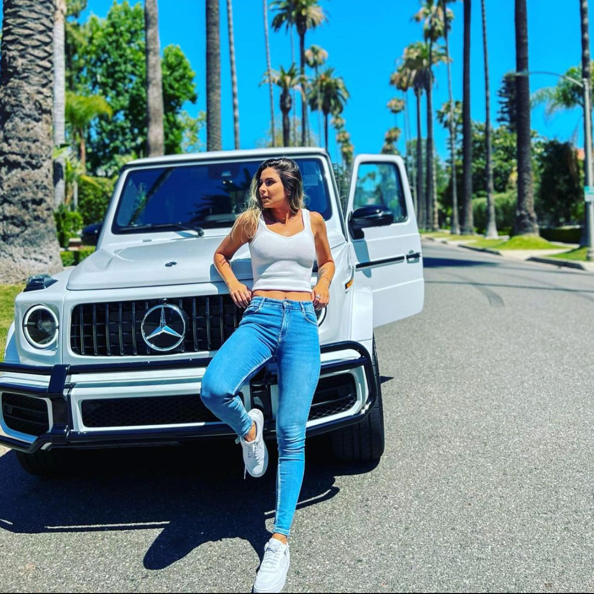 Mercedes Benz G 63 AMG white luxury suv 4x4 car rental with a woman in front of it
