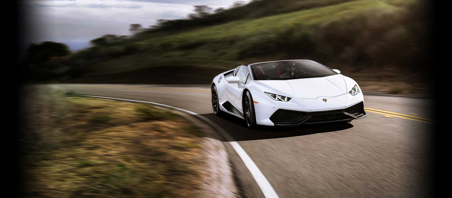 white exotic car rental on the road in los angeles